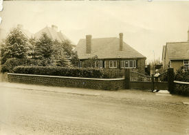 Clara Udall (nee Yeomans) at the gate of Apsley Sweetpool Lane in about 1930. Clara had 10 children during her life.